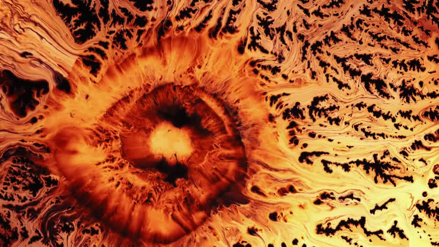 An orange colored liquid is flowing outwards