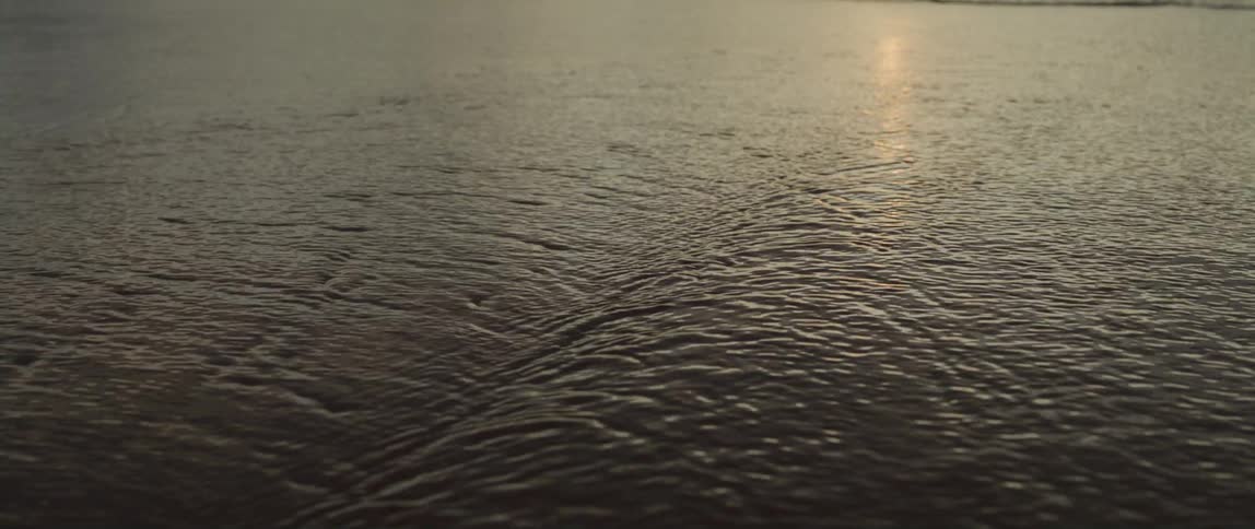The sun shines on the water as it ripples and waves in the light