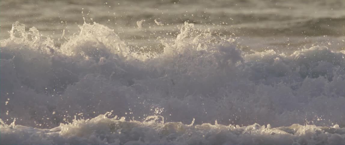 The waves crash in the ocean