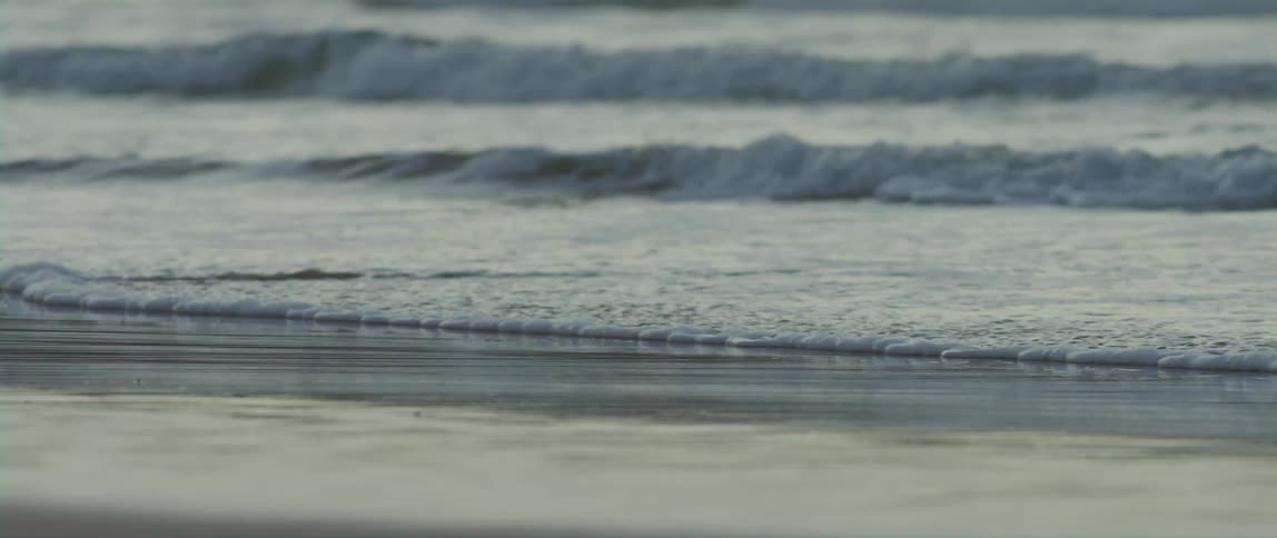 The ocean waves crashing onto the beach