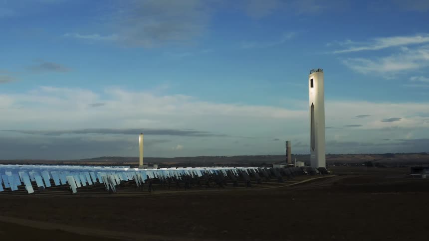 Solar farm concentrating sunlight on the solar collector towers in the desert