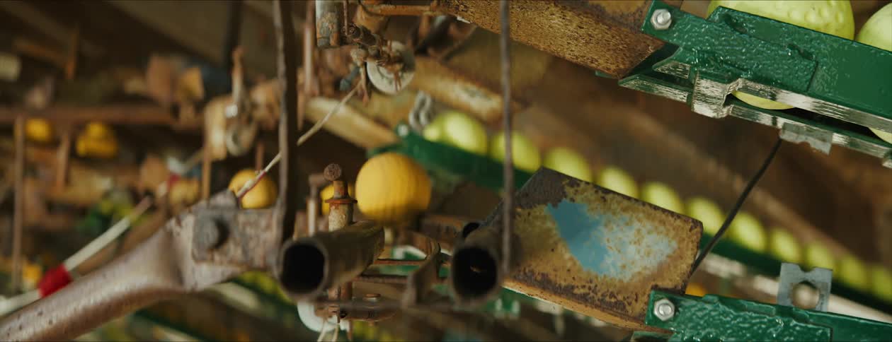 Yellow balls running through an automated sorting machine