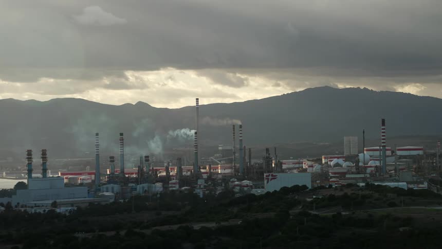 Many manufacturing plants and their chimneys fill air with smog