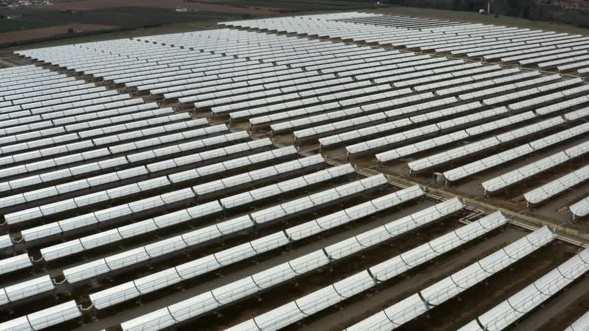 Endless rows of solar panels on a solar farm during the day