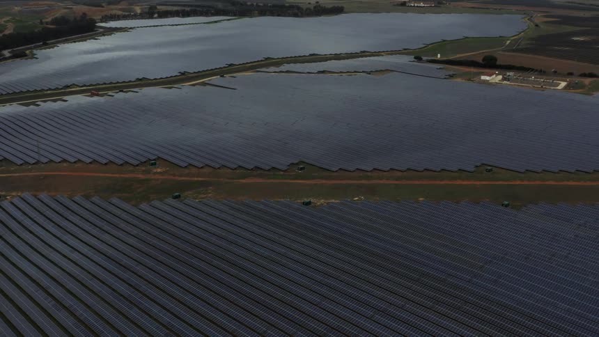 Roads cross between endless fields full of solar panels