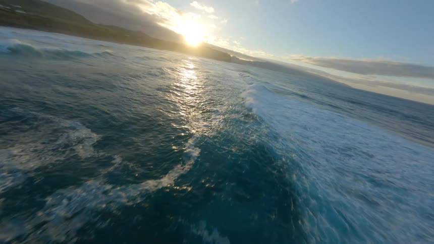 The view is of the ocean and the waves in the day time