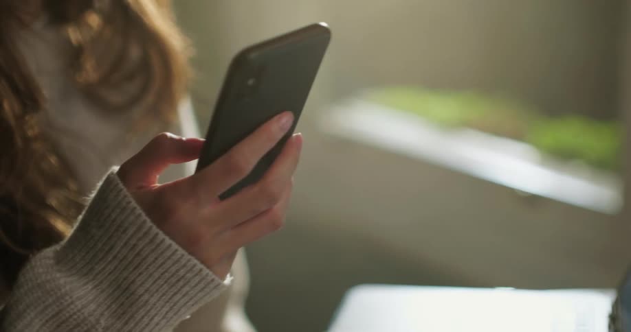 Gen-Z female hands dialling on smartphone
