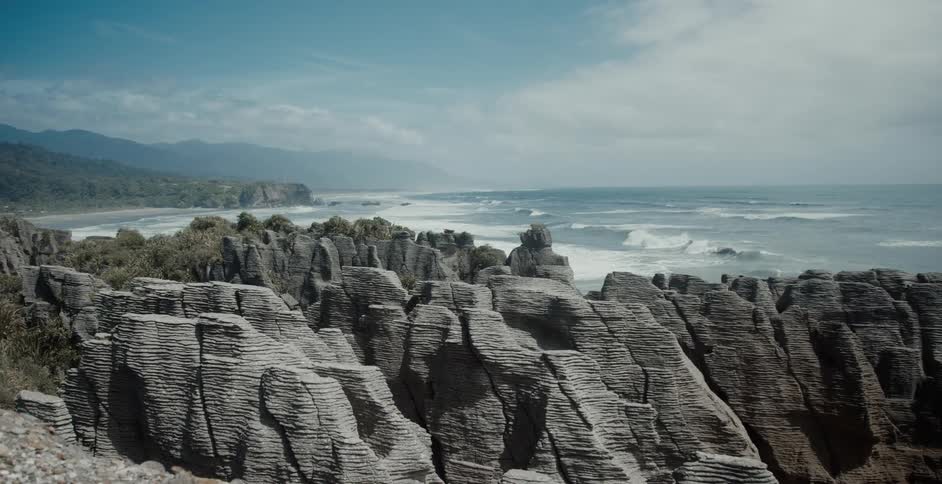 A rock formation on the coast during the day