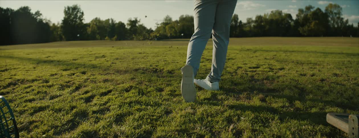 Golfer hits golf ball and grass at the same time