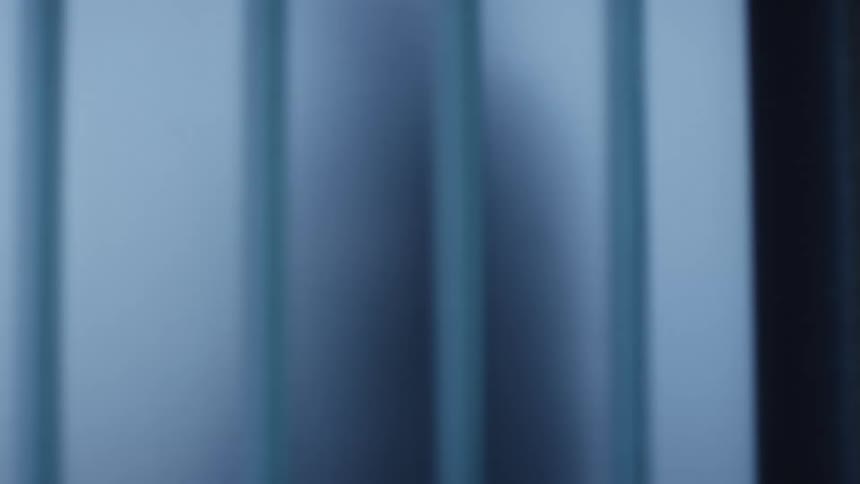 A person walking by a window in an office