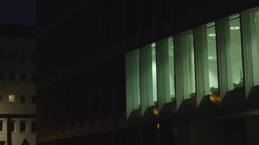 Lights of a whole floor of offices on a building in the city light up at night
