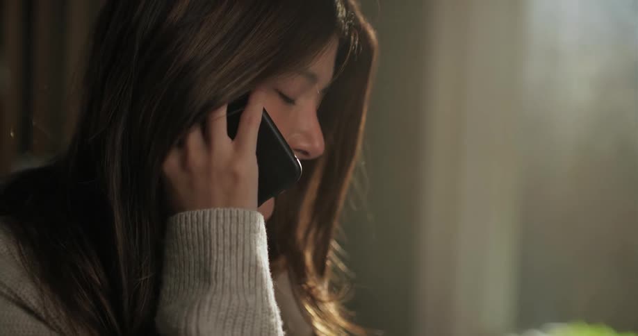 Young woman on mobile phone in cafe