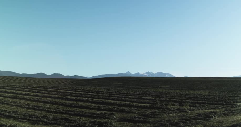 A landscape view of flat lands with hills in the far distance