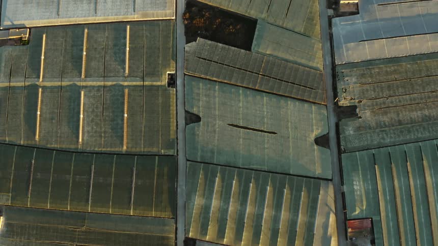 Top down aerial view of the interconnected rooftops of several warehouses