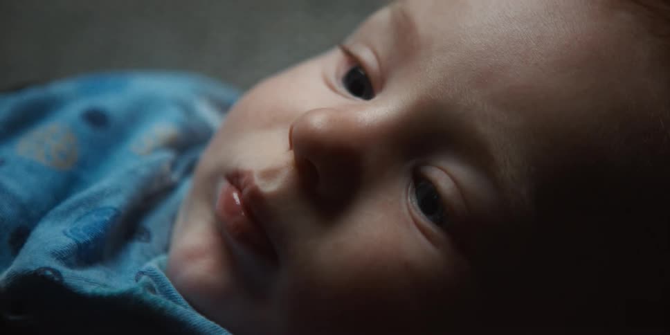 Close up of babys face staring up