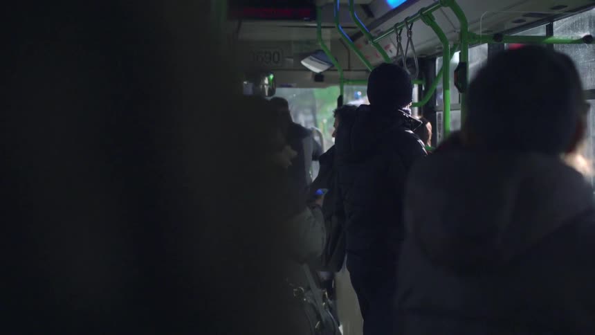 People stand on a bus