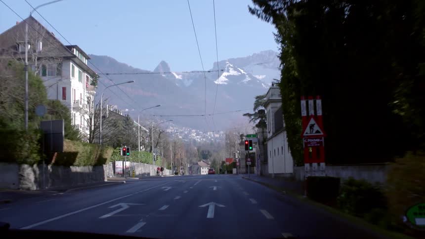 Moving down a town road with a mountain in the distance