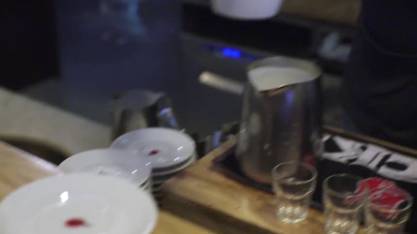 A person puts a cup on a saucer