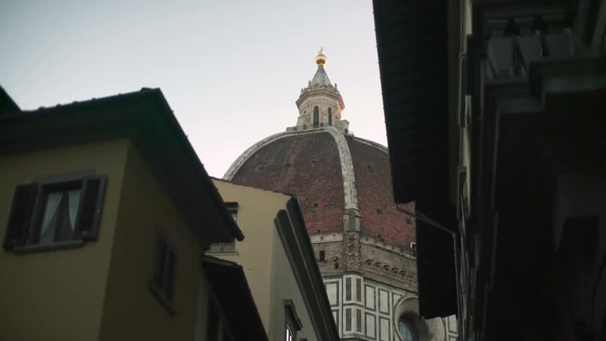 The dome of a cathedral hovers above old buildings