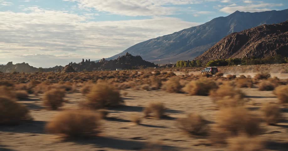 Someone is driving a vehicle in the middle of the desert