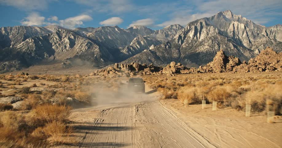 A car is driving off road through a landscape