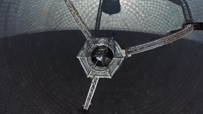 Top down twisting aerial view of the tower inside a radio telescope