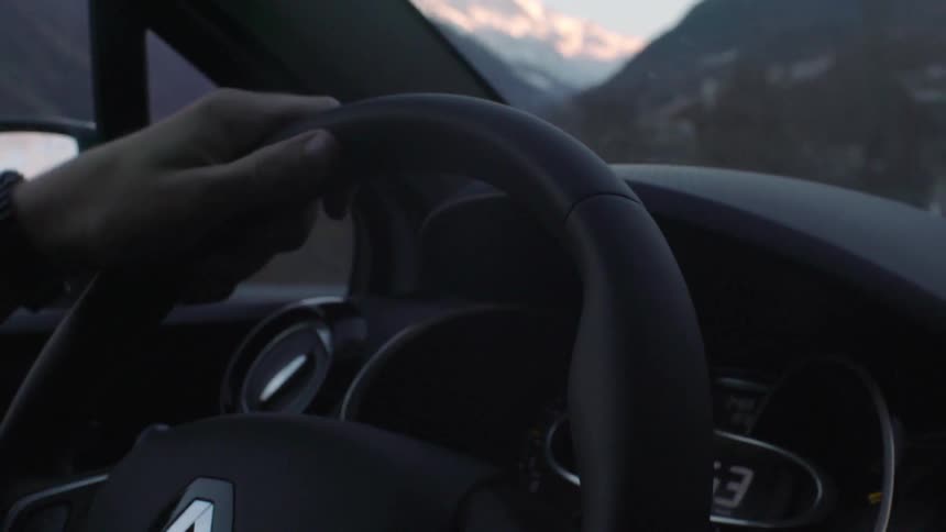 A person is steering a wheel while driving