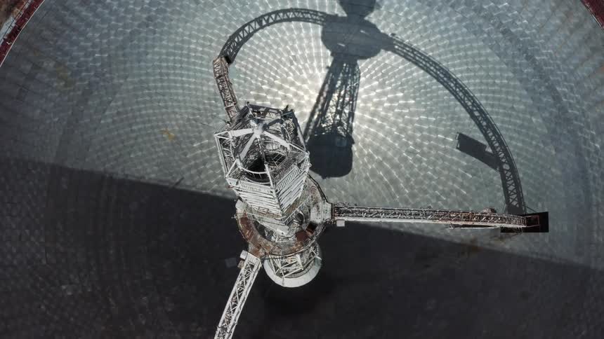 Top dow twisting aerial view of the interior structures on a giant radio telescope