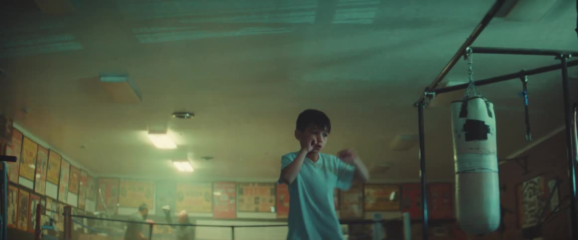 Young boy shadow boxing indoors in a gym
