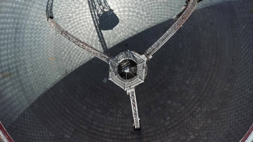 Top dow twisting aerial view of the interior structures on a giant radio telescope