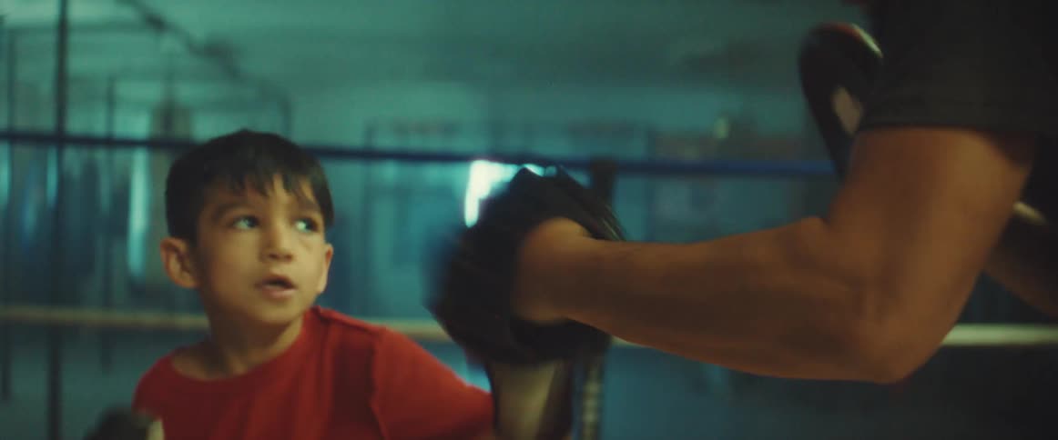 A child and adult practicing boxing