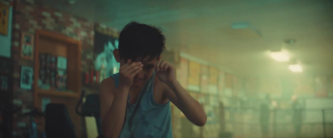 A child is shadowboxing in the gym