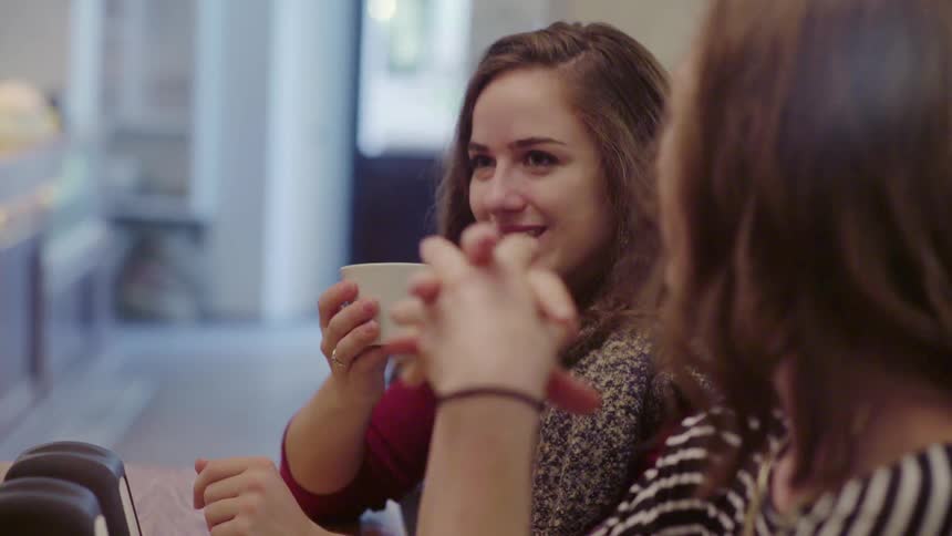 Women talk and laugh at a table