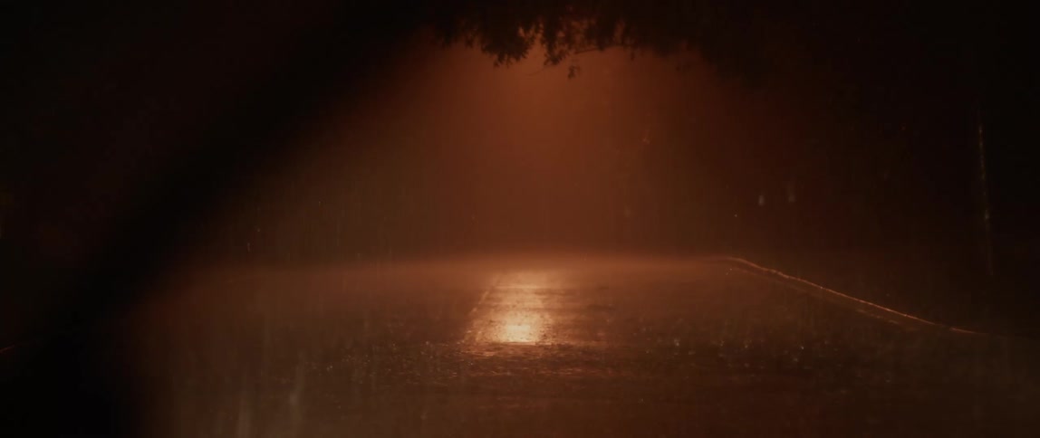 Interior view of parked car with windshield wipers on during a rainstorm