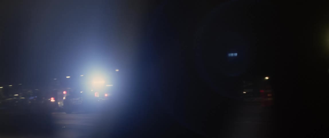 Police cars and a car parked on the side of the highway