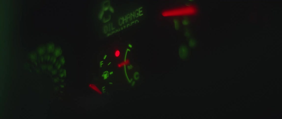 Gauges on a vehicle are lit up and move in the dark