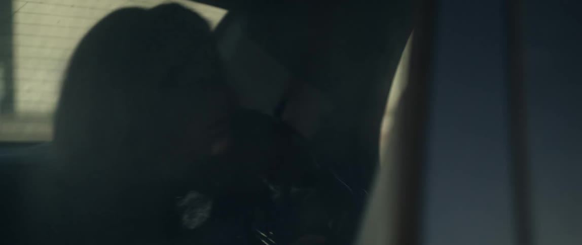 Woman sitting on the back seat of a car puts on a jacket and goes to sleep