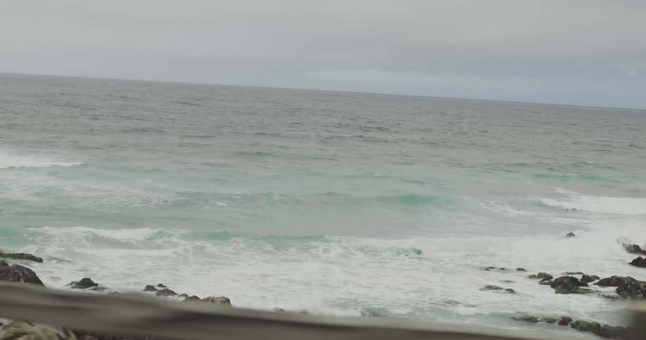 Waves crash onto rocks along the coast