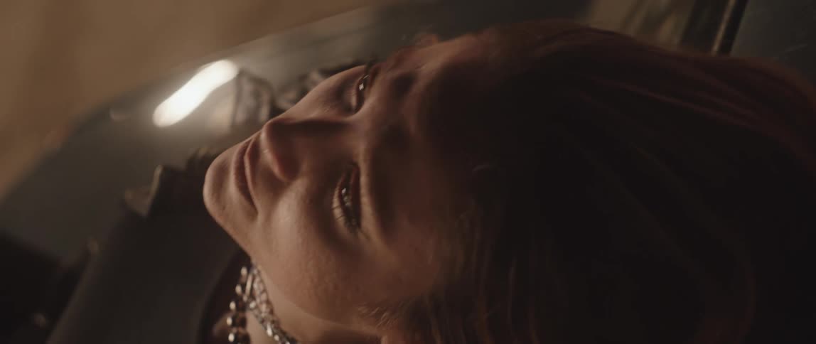 A young man leans back and looks up at the ceiling