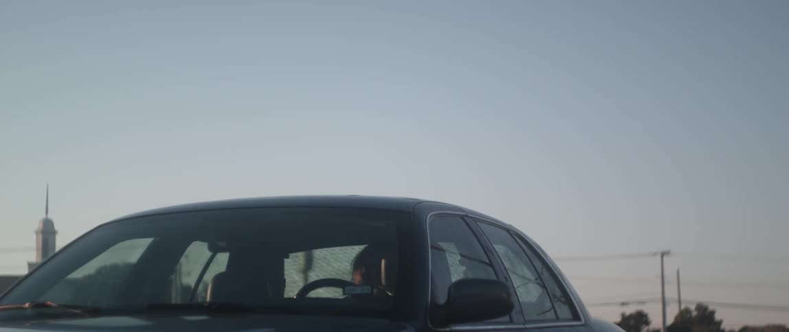 A young white woman is getting out of the vehicle to go outside