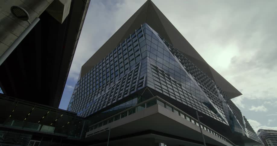 The facade of a stylishly designed building on a cloudy day