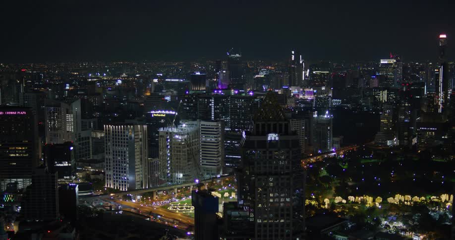Traffic flows through downtown at night