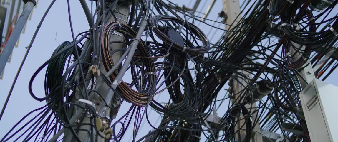 Many rolls of black wires and coils attached to posts