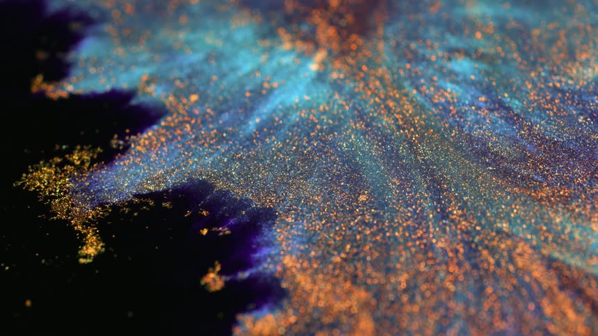 Blue and bronze glitter spread out in resin