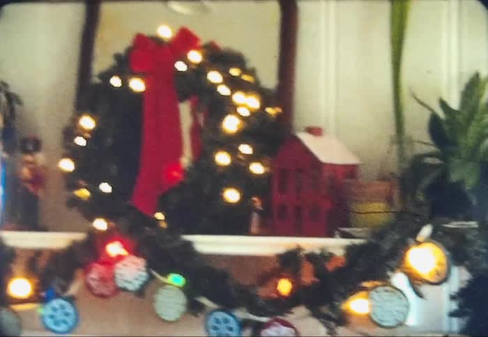 Christmas decor is on a fireplace in a house