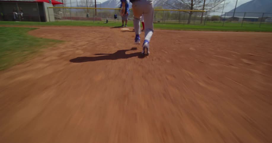 Kids are playing baseball and are running outside