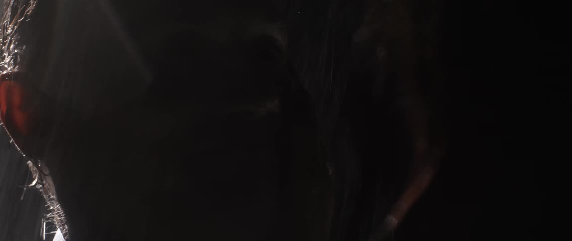 Two people are standing out in the rain and are hugging each other