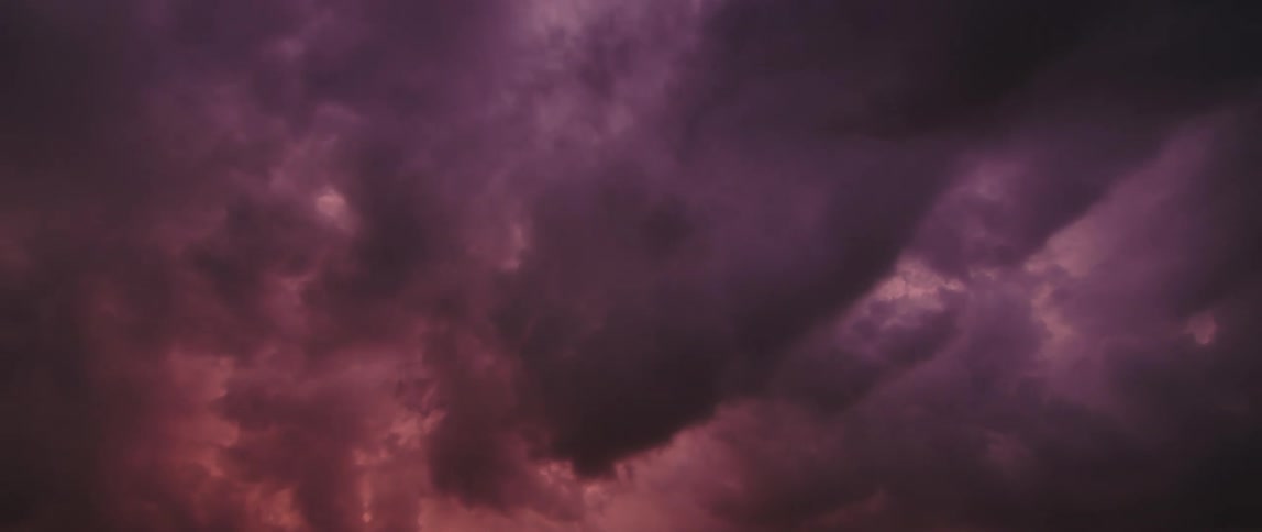 Time lapse of rolling clouds changing colours at sunset