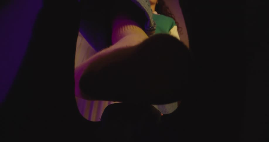 A teenage girl at home putting her foot in to a shoe