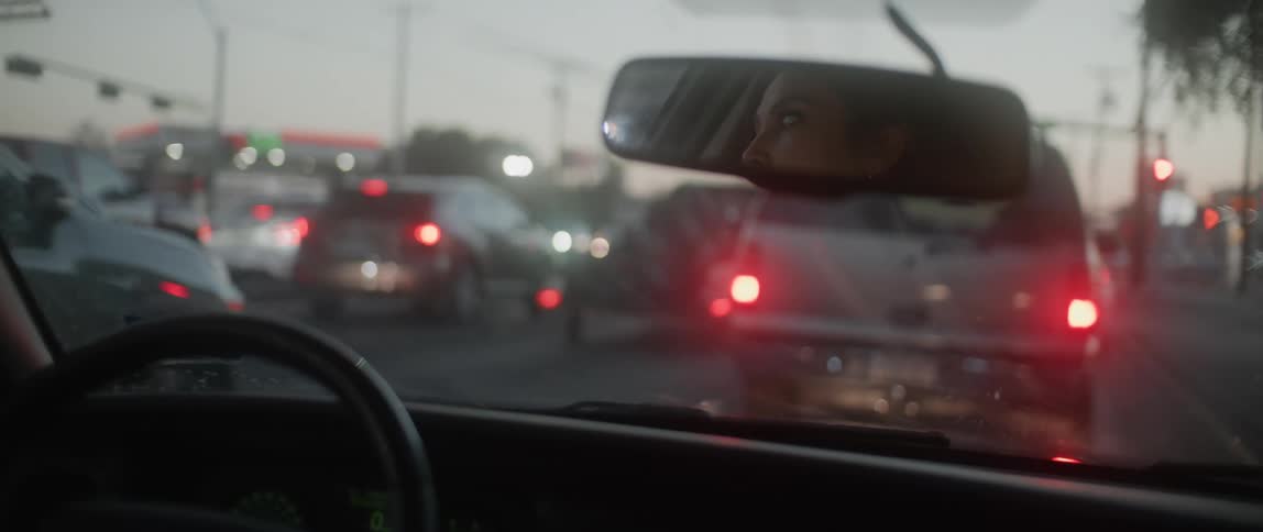 There are cars that are driving and that have stopped at the red light